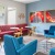 a room with colorful chairs and a table