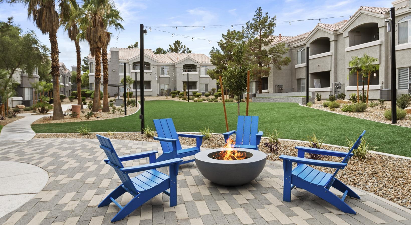 Settle into comfort at FireSkye a group of chairs and a fire pit on a patio